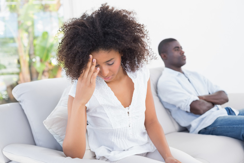 Attractive couple having an argument on couch at home in the living room