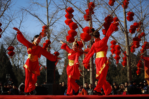 Chinese dancers dressed in traditional costumes perform a cultural dance on stage during a temple fair for a Lunar New Year celebration in Beijing, Monday, Feb. 8, 2016. Millions of Chinese began celebrating the Lunar New Year, which marks the Year of the Monkey on the Chinese zodiac. (AP Photo/Andy Wong)