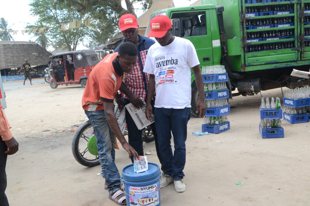 5.Mmoja wa washiriki wa Droo ya Bahati Nasibu ya Shinda Nyumba mkazi wa eneo la Goba mwisho akiweka kuponi yake.