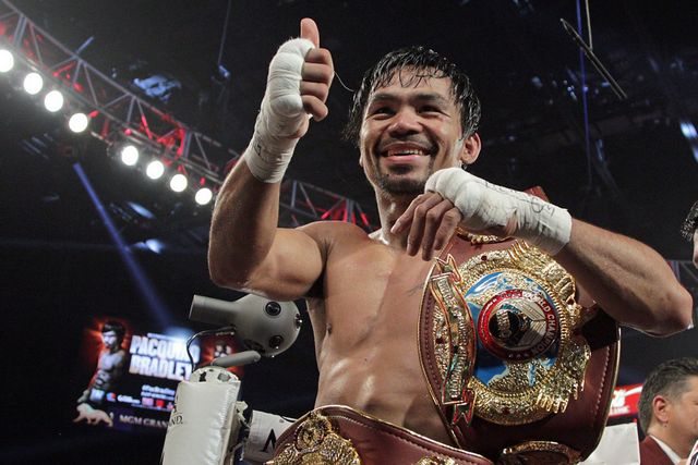 Manny-Pacquiao-gestures-to-fans-as-he-celebrates-after-defeating-Timothy-Bradley-Jr