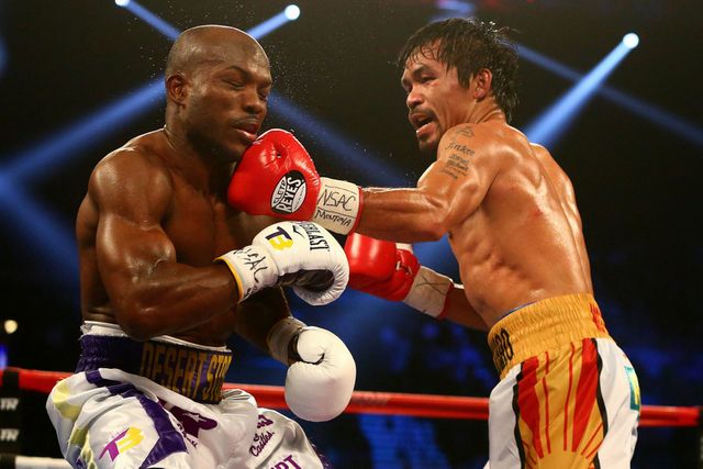 Manny-Pacquiao-lands-a-punch-to-bring-down-Timothy-Bradley