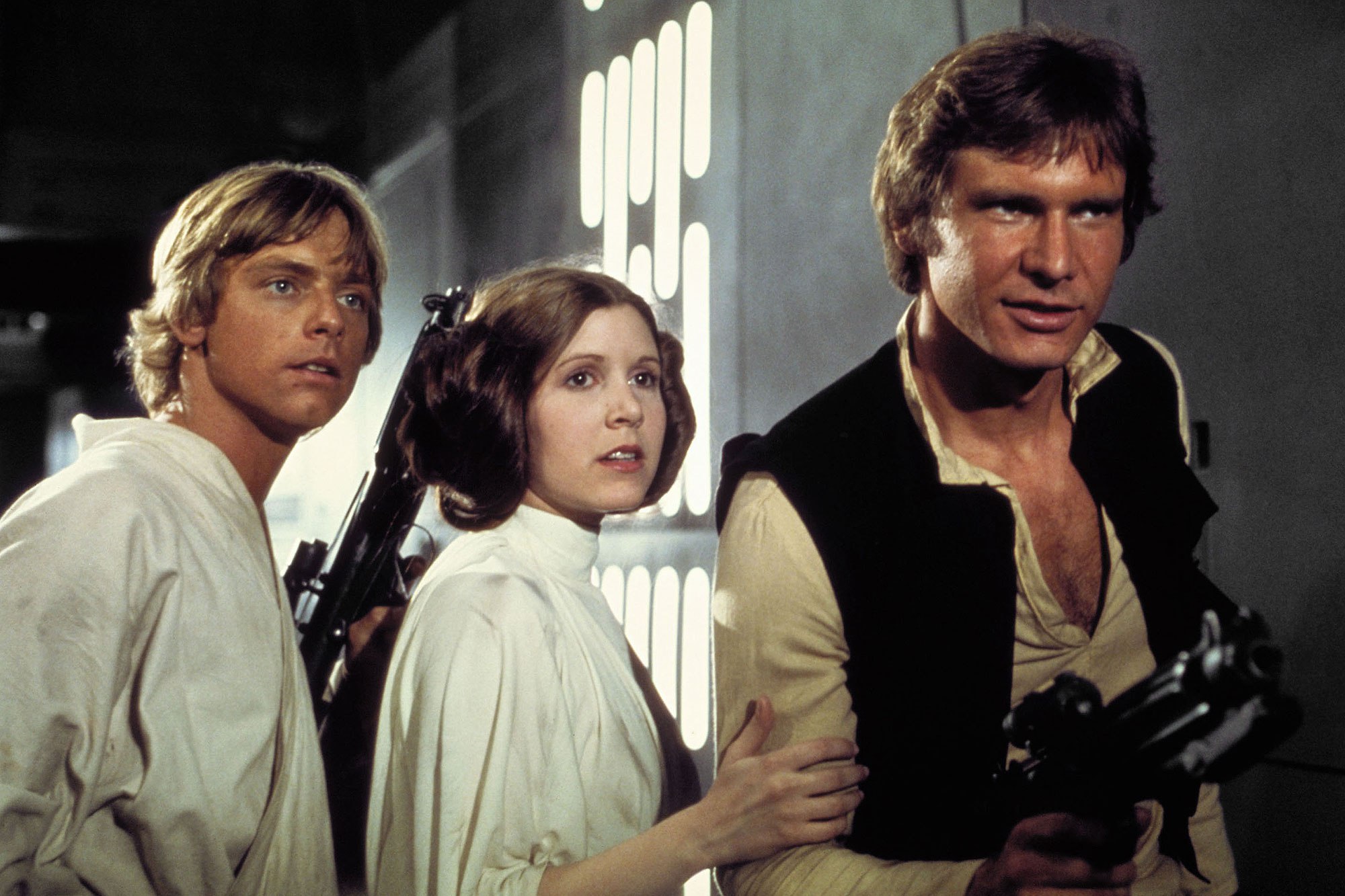 No Merchandising. Editorial Use Only. No Book Cover Usage. Mandatory Credit: Photo by Lucasfilm/20th Century Fox/REX/Shutterstock (5886297bq) Mark Hamill, Carrie Fisher, Harrison Ford Star Wars Episode IV - A New Hope - 1977 Director: George Lucas Lucasfilm/20th Century Fox USA Scene Still Scifi Star Wars (1977) La Guerre des étoiles