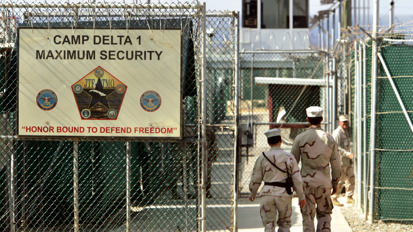 In this June 27, 2006, file photo U.S. military guards walk within Camp Delta at the Guantanamo Bay U.S. Naval Base, Cuba. The U.S. announced the transfer of four detainees from Guantanamo to Oman; one will go to Estonia.