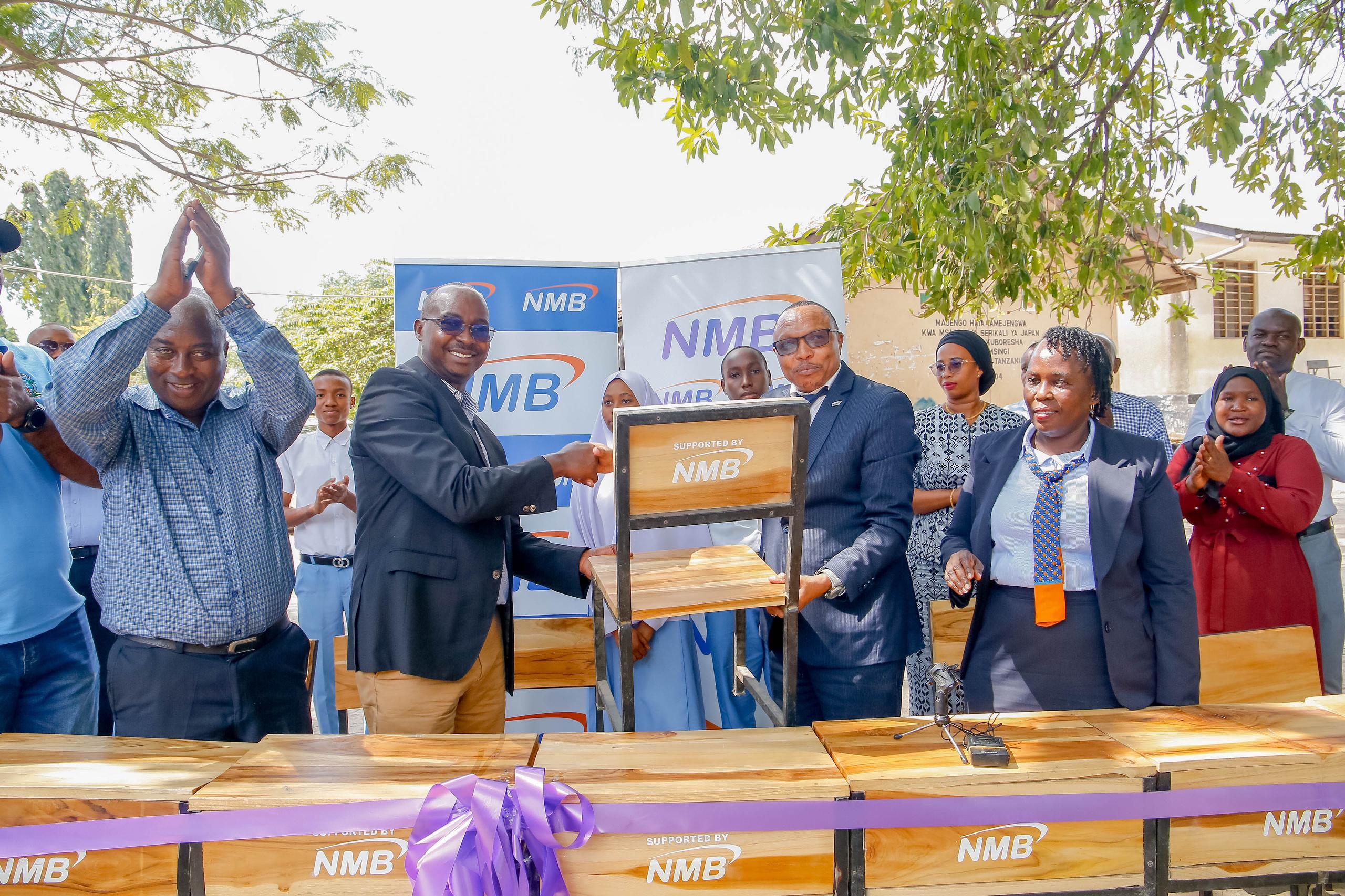 NMB Yaipiga Tafu Shule Mbili Za Sekondari Dar , Yakabidhi Meza Na Viti - Global Publishers